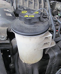 power-steering-reservoir_Rich-Ellis_200x240 a power steering fluid reservoir under the hood