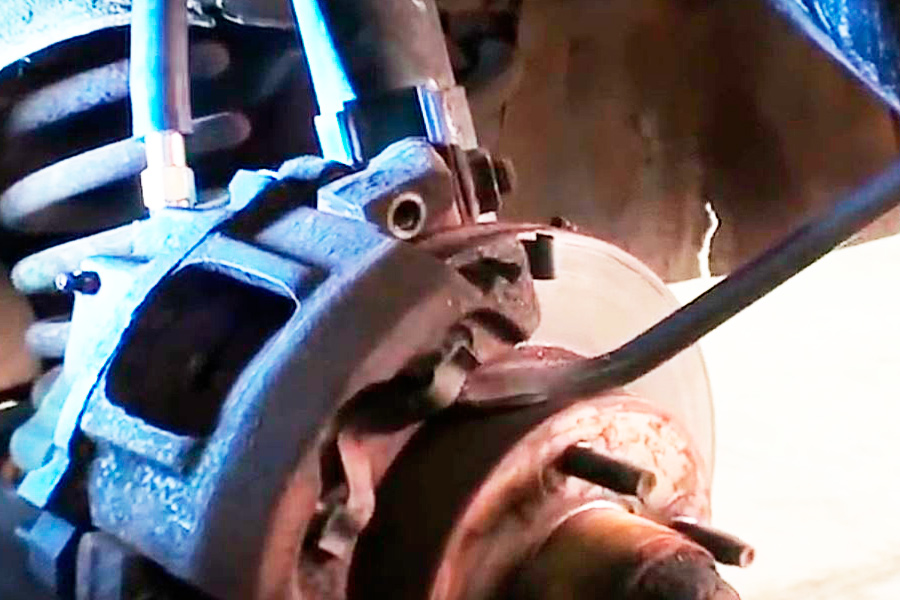 Remove stuck caliper with pry bar