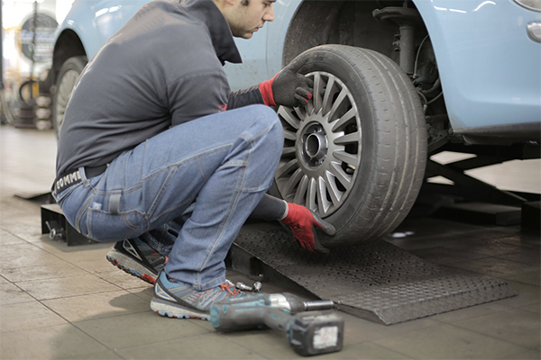 man removing a wheel