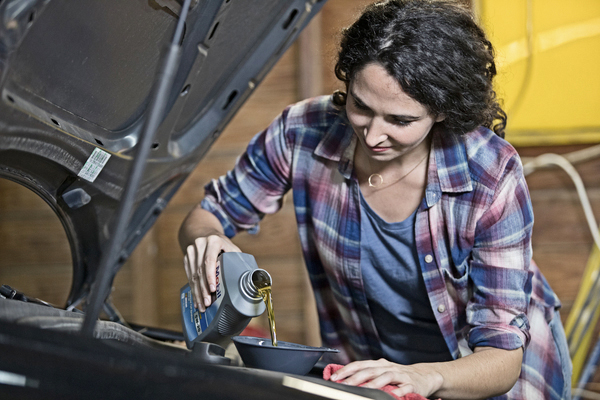 a woman pouring oil