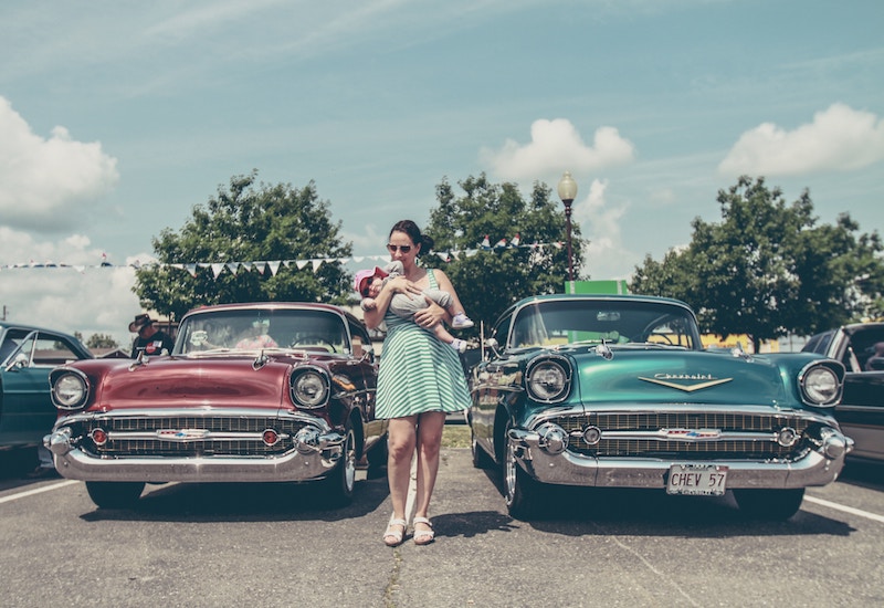 woman and child in used car sales lot